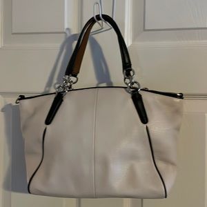 Coach cream with black accent handbag.